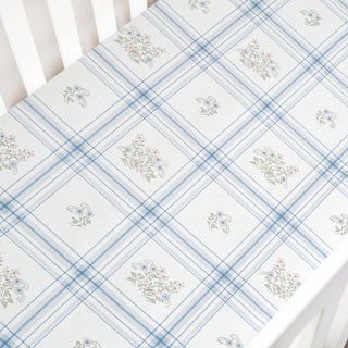 Floral patterned fabric with blue and white checkered design on a white background