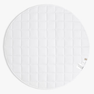 Round white mat with a textured pattern on a white background