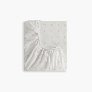 Floral patterned crib sheet fitted sheet on a white background