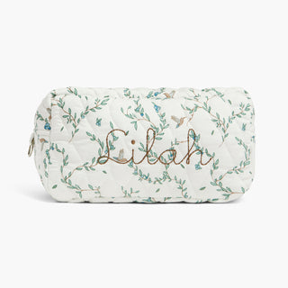 Quilted pouch with floral patterns and 'Lilah' embroidery on a white background