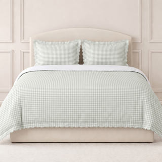 Picnic Gingham  light green bedding set on a bed with a neutral headboard.