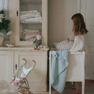 Girl In Room Making Bassinet 