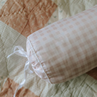 Closeup of pink bolster pillow. 