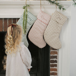 Christmas Stocking in  Gingham hanging on fireplace for Holiday decor