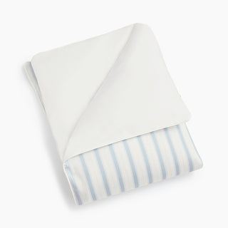 Folded ivory child's duvet with blue stripes on a white background