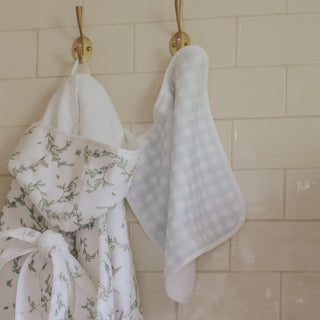 washcloth of blue gingham hanging on wall