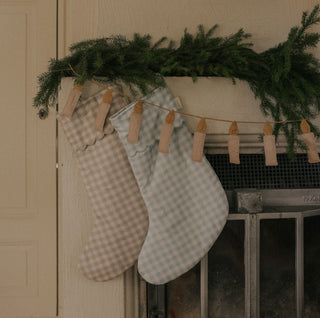 Candle Gardland with Gingham Stockings hanging on fireplace for Holiday decor. 