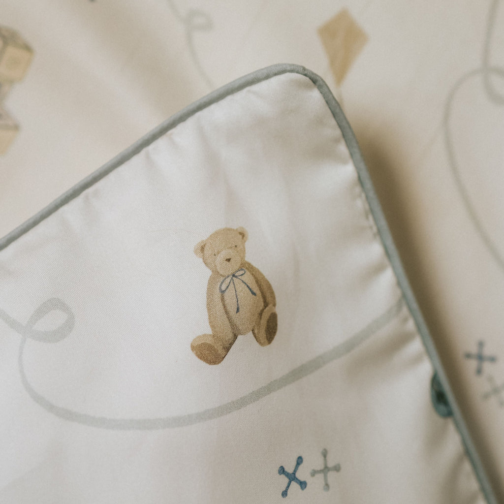 Close up of a teddy bear design on a pillow