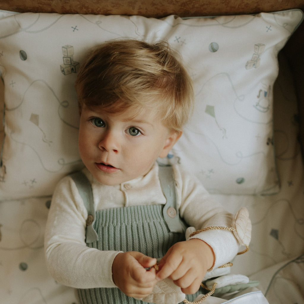 Child in a crib with patterned bedding