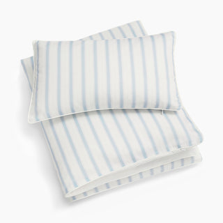 Blue and ivory striped bed sheet and pillowcase set on a white background