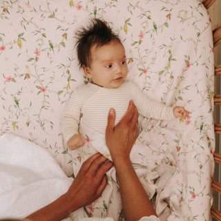 Baby laying in crib with Dreaming of Paradise Print