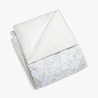 Folded fabric with Animal Parade pattern in blue on a white background