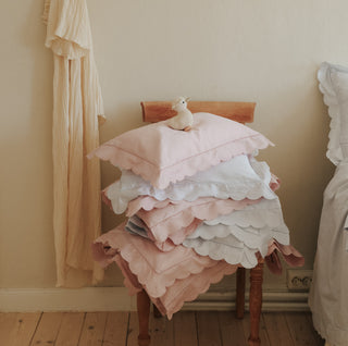 Scalloped Starlight duvets and pillows stacked