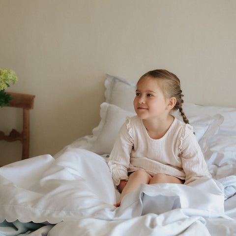 Scalloped Starlight Full Queen Duvet in Blue with child sitting in bed