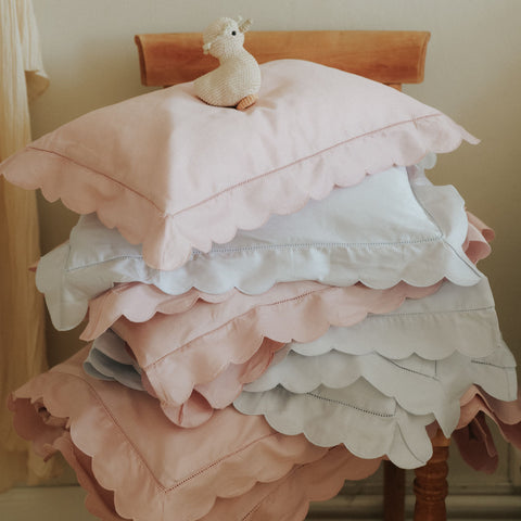Scalloped Starlight Pillowcase stacked in Blue and Rose.