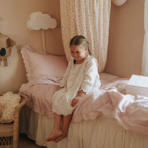 Scalloped Starlight Twin Duvet Set in Rose with little girl on bed smiling