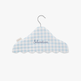 Blue and white checkered cloud-shaped hanger with 'Sebastian' embroidery on a white background