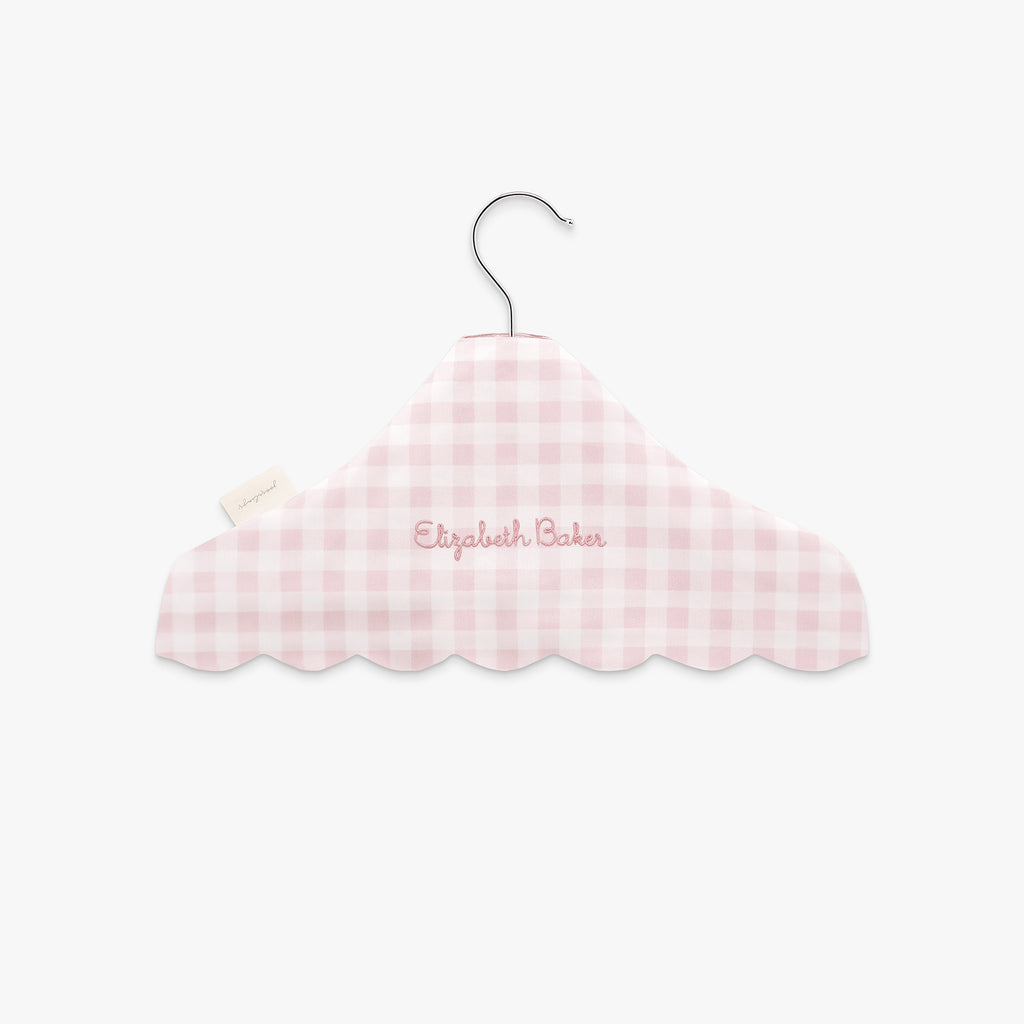 Personalize Me: Pink gingham-patterned hanger with 'Elizabeth Baker' embroidery on a white background