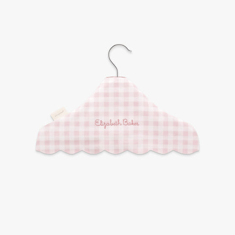 Pink gingham-patterned hanger with 'Elizabeth Baker' embroidery on a white background