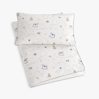 Children's bedding set with patterned duvet and pillowcase on a white background