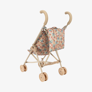 Back of floral doll stroller with hanging pouch.