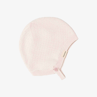 A light pink knit baby bonnet with a small button closure
