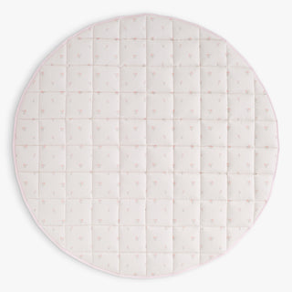 Round quilted play mat with a pink floral pattern on a white background