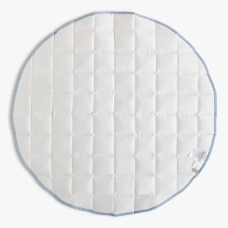 Round quilted pad with blue trim on a white background