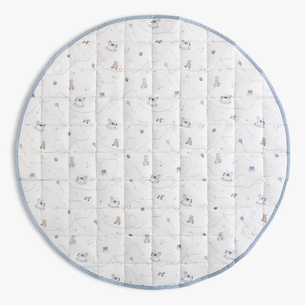 Round baby play mat with toys pattern on a white background