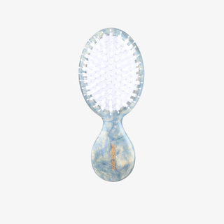 Light blue baby hairbrush on a white background