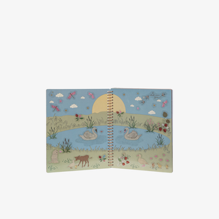 Spiral-bound notebook with a nature-themed design on a white background