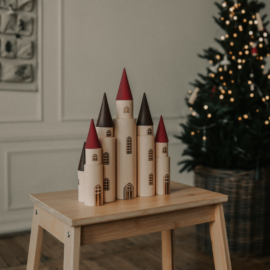 Fairytale Kingdom Tower with wooden cones set up on a bench 