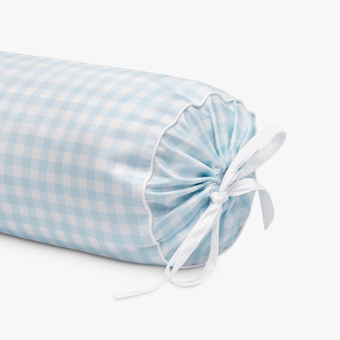 Rolled-up blue and white checkered fabric with a white ribbon on a light gray background