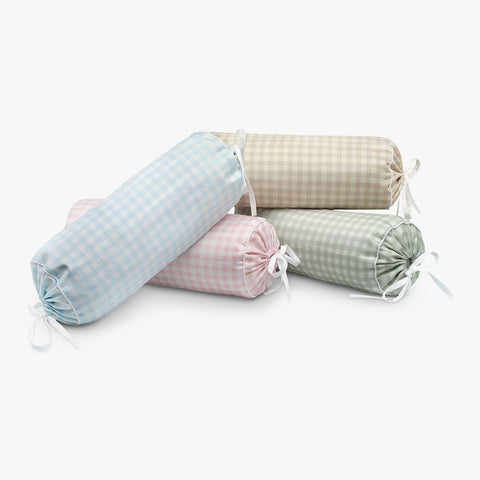 Set of four rolled-up checkered pillows in pastel colors on a white background