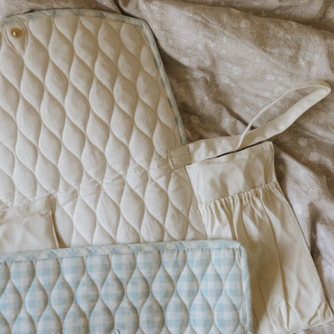 Portable Changing Pad in Blue Gingham and Ivory on the inside.