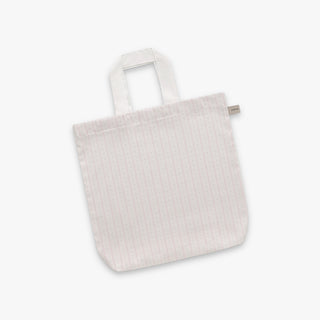 White textured tote bag on a light gray background