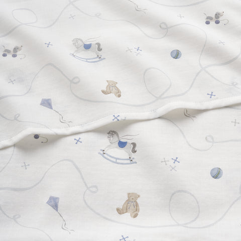 White fabric with patterns of teddy bears and rocking horses on a white background