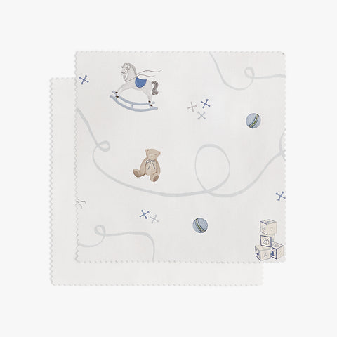 White fabric swatch with teddy bear and toys on a white background