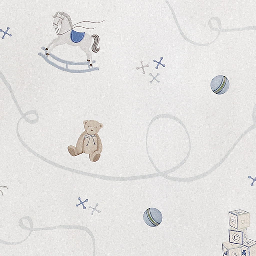 White fabric with patterns of teddy bears and rocking horses on a white background