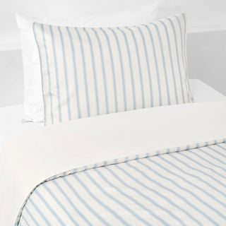 Striped bed sheet and pillowcase set on a white background