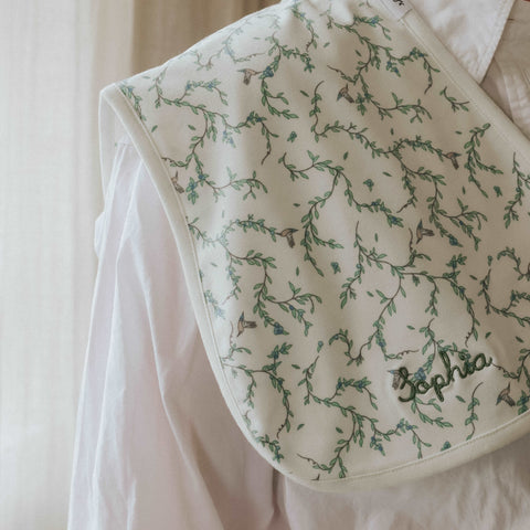 Secret Garden Burp Cloth on mothers shoulder