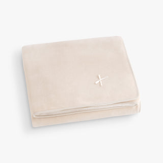 Beige blanket with a bow on a light gray background
