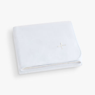 Blue blanket with a white bow. 
