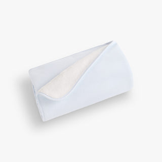 Blue blanket with a textured interior on a white background