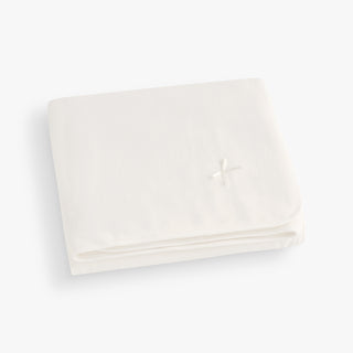Ivory blanket, folded. 