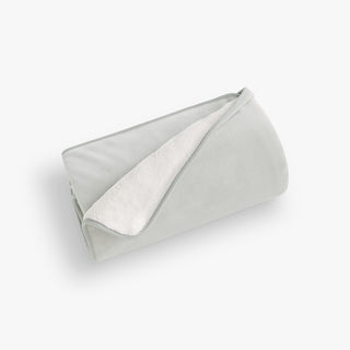 Folded light green fabric on a white background