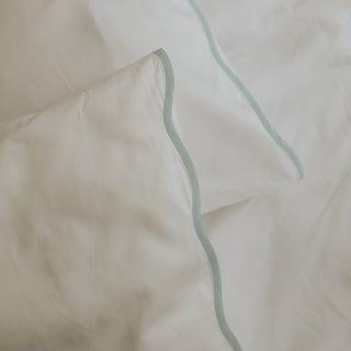 Close-up of white pillow with Blue trim wave detail