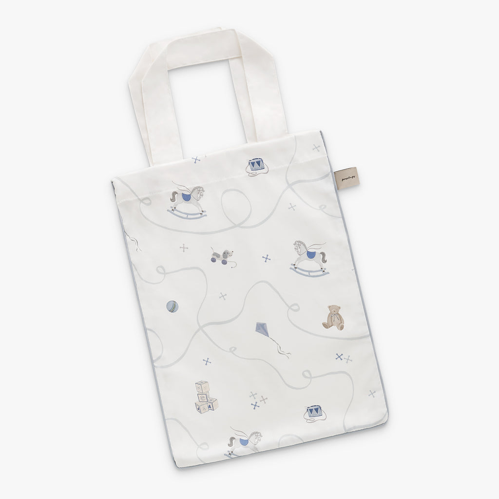 White tote bag with teddy bear and toy pattern on a white background
