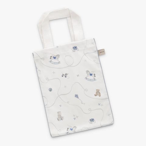 White tote bag with teddy bear and toy pattern on a white background