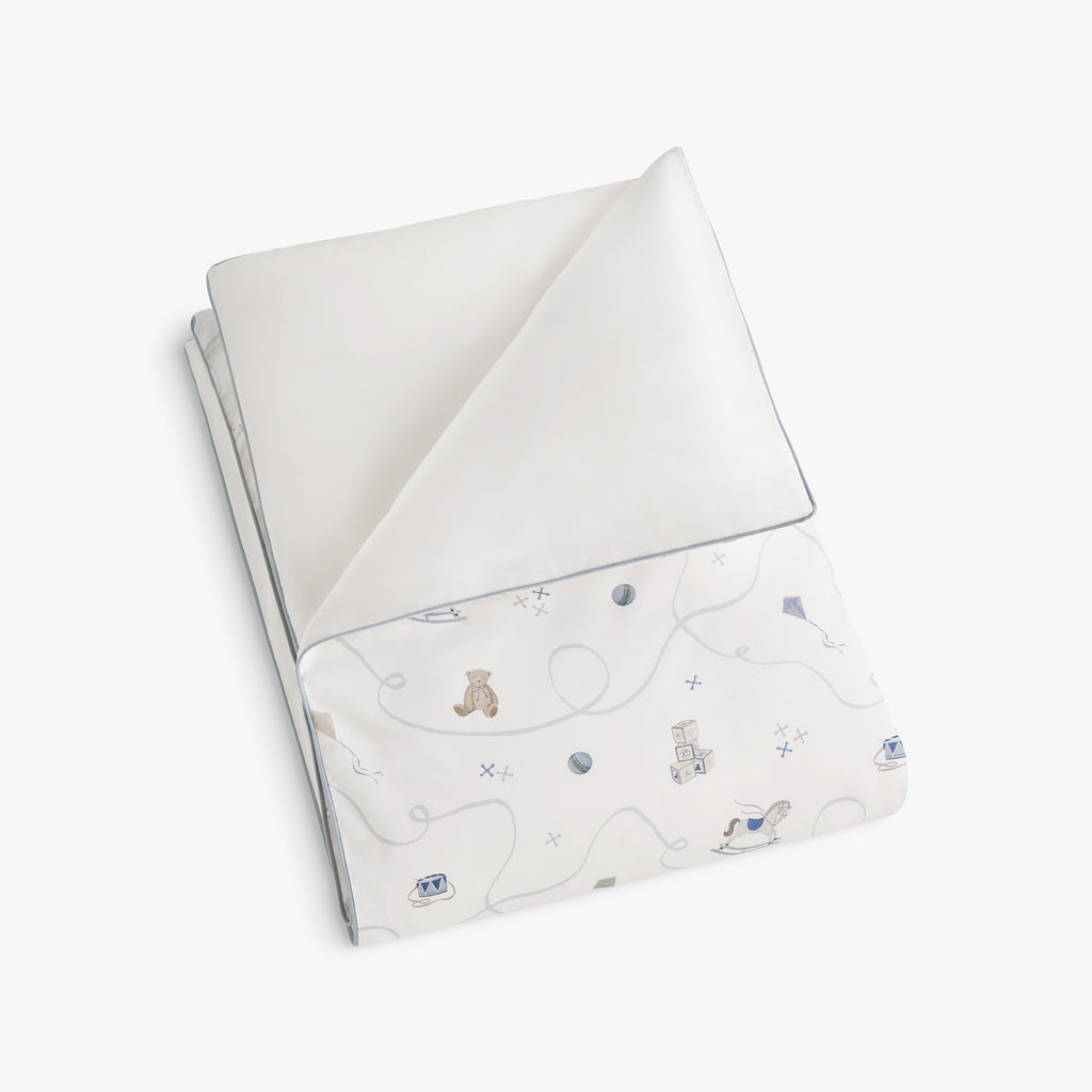 Personalize Me: folded rocking horse and teddy bear patterned blanket on a white background